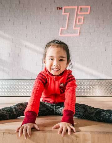 happy junior Fitness First member in workout studio