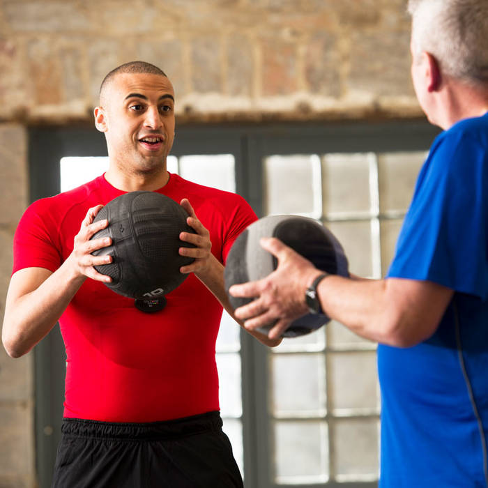 Fitness First members using medicine balls Fitness First members using medicine balls