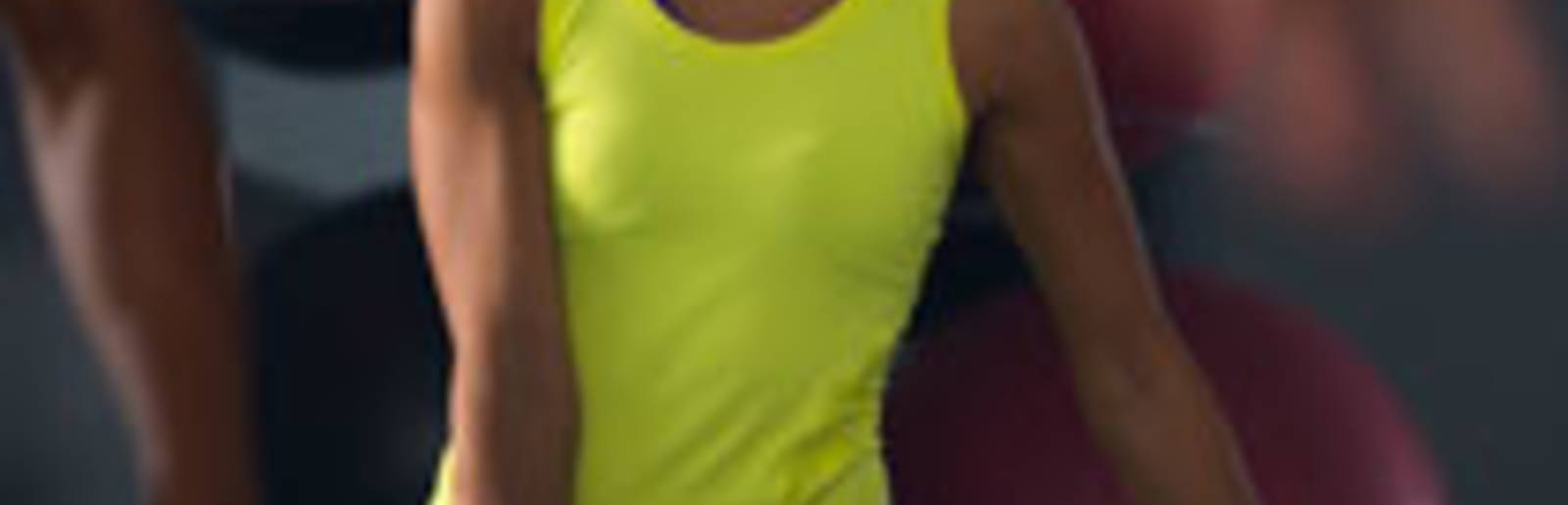 Gym member kettle-bell exercise